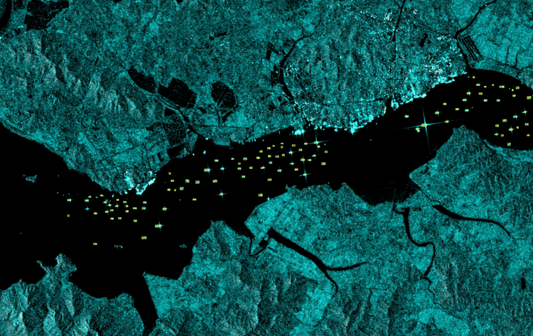 A black and white satellite image of Taedong River with ships outlined with yellow boxes