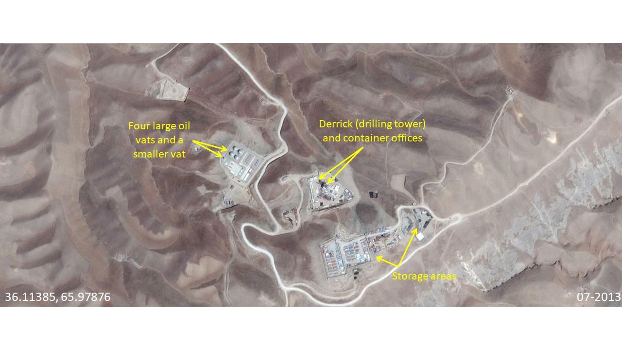 Kashkari oil field facilities in 2013. Three main areas were developed - crude oil vats on the left, a drilling tower with container offices in the center, and a storage area near the bottom of the image. Copyright Google Earth 2013.