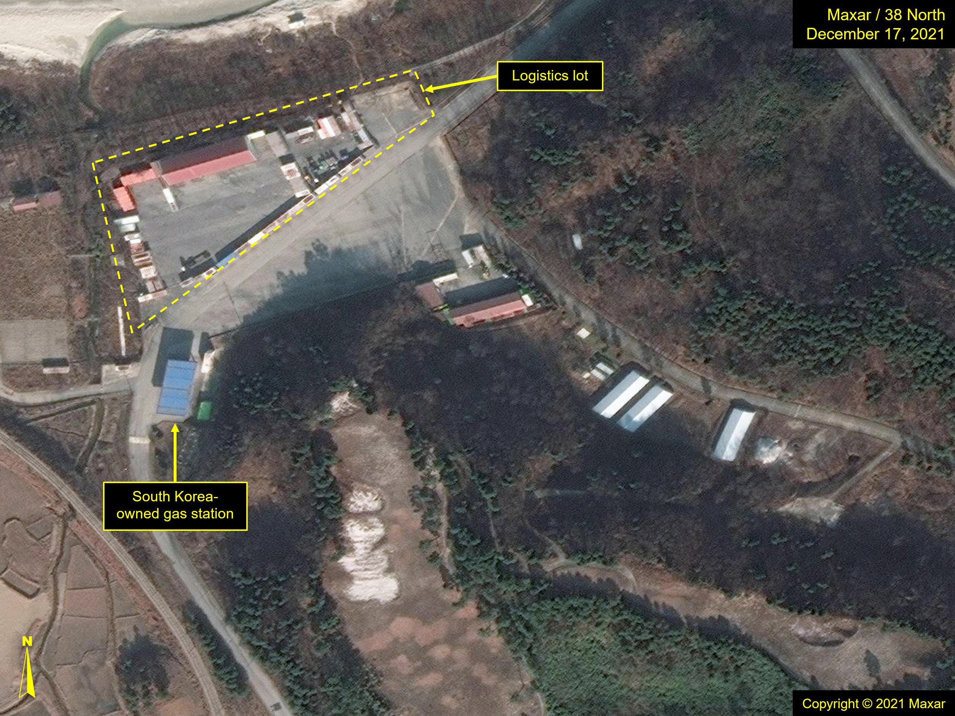 Figure 12. Storage and vehicles observed in lot adjacent to South Korean-owned gas station on imagery from December 2021.